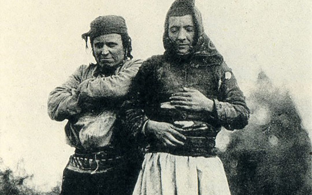 Two persons in a black and white photo, one of them with their eyes closed