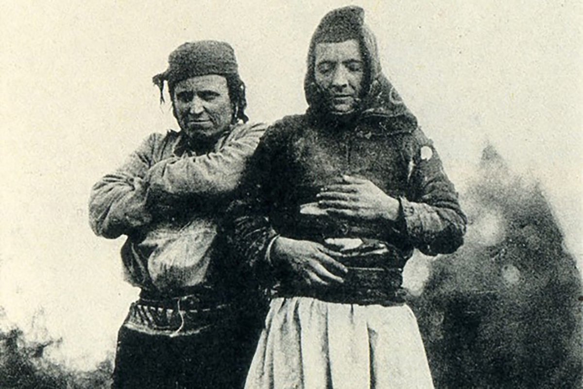 Two persons in a black and white photo, one of them with their eyes closed