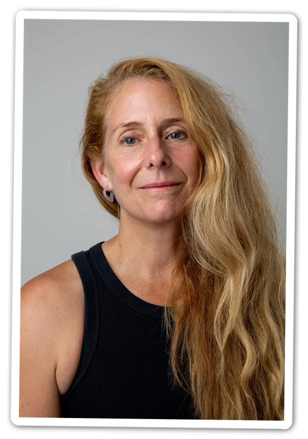 A portrait of a woman in a black sleeveless shirt with blond hair